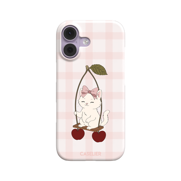 Cherry Swing phone case featuring a white cartoon kitten with a pink bow sitting on a cherry-suspended swing over a blush pink gingham background, phone case by Caselier — snap case, front view