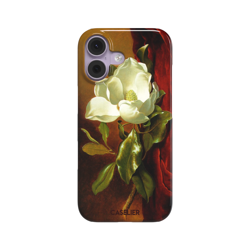 A Magnolia on Red Velvet by Martin Johnson Heade phone case showing a luminous white magnolia bloom with deep green leaves against rich red velvet drapery on a warm amber background, phone case by Caselier — snap case, front view