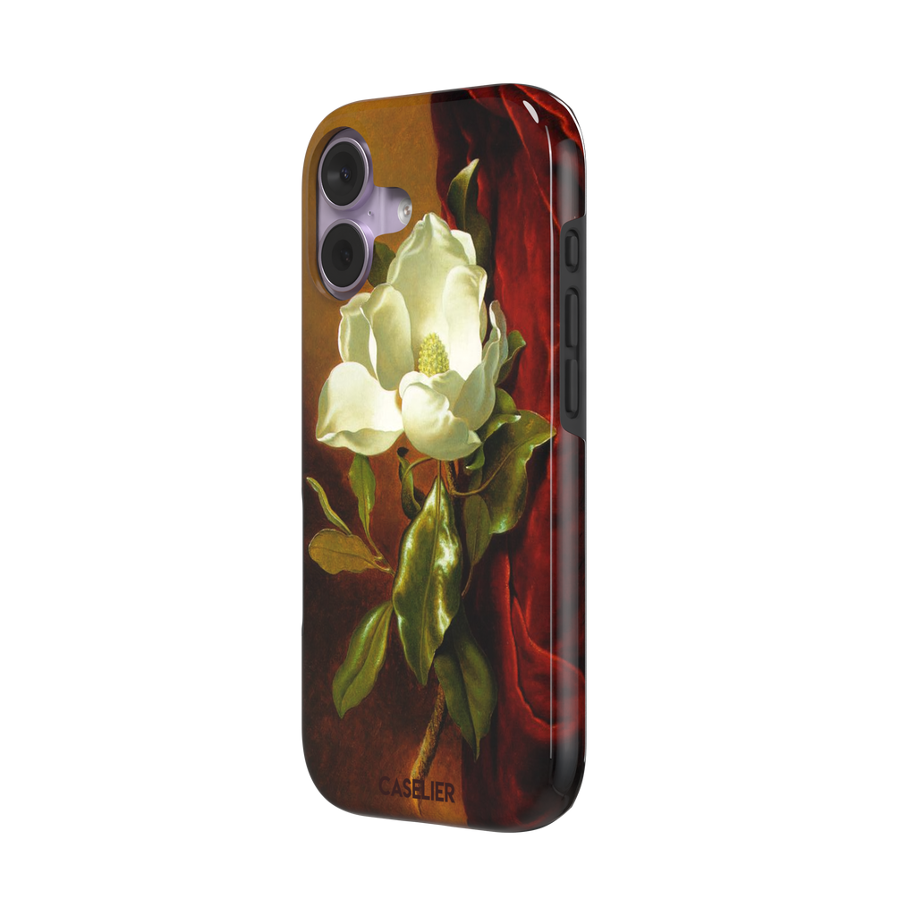 A Magnolia on Red Velvet by Martin Johnson Heade phone case showing a luminous white magnolia bloom with deep green leaves against rich red velvet drapery on a warm amber background, phone case by Caselier — tough case, right view