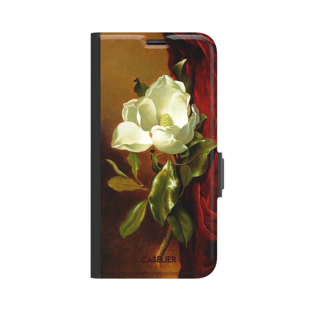 A Magnolia on Red Velvet by Martin Johnson Heade phone case showing a luminous white magnolia bloom with deep green leaves against rich red velvet drapery on a warm amber background, phone case by Caselier — wallet case, front view