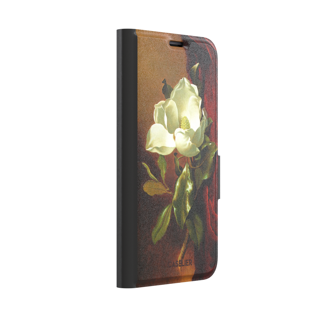 A Magnolia on Red Velvet by Martin Johnson Heade phone case showing a luminous white magnolia bloom with deep green leaves against rich red velvet drapery on a warm amber background, phone case by Caselier — wallet case, left view