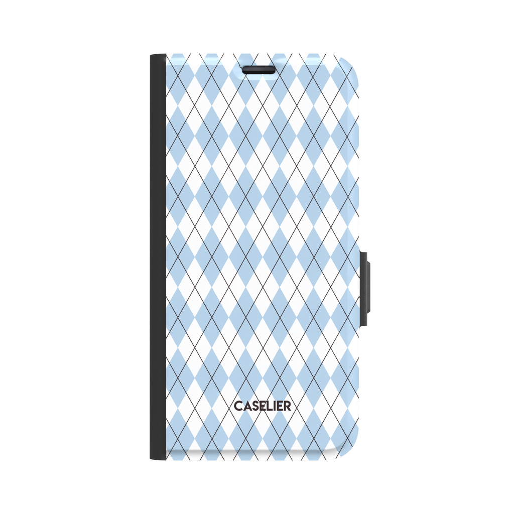 Argyle pattern folio wallet case in powder blue and white with dark crosslines, three-quarter angled view showing black spine and magnetic clasp, phone case by Caselier - wallet case, front view | Caselier