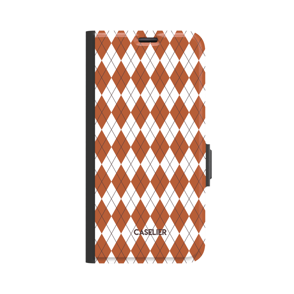 Argyle pattern folio wallet case in burnt orange and white with dark crosslines, three-quarter angled view showing black spine and magnetic clasp, phone case by Caselier - wallet case, front view | Caselier
