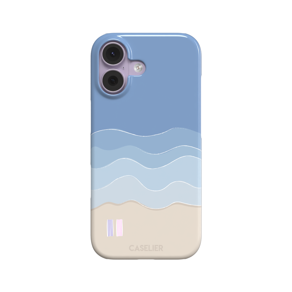 Beach phone case featuring layered blue waves graduating to a sandy beige shore with two miniature striped beach umbrellas, from the Memories of Summer collection, phone case by Caselier — snap case, front view
