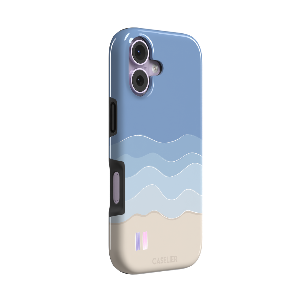 Beach phone case featuring layered blue waves graduating to a sandy beige shore with two miniature striped beach umbrellas, from the Memories of Summer collection, phone case by Caselier — tough case, left view