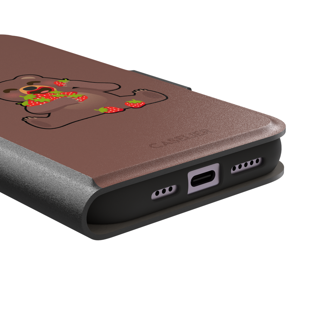 Warm brown phone case featuring a cartoon bear happily eating a pile of red strawberries, from the Emoji Mix collection, phone case by Caselier — wallet case, charging port detail