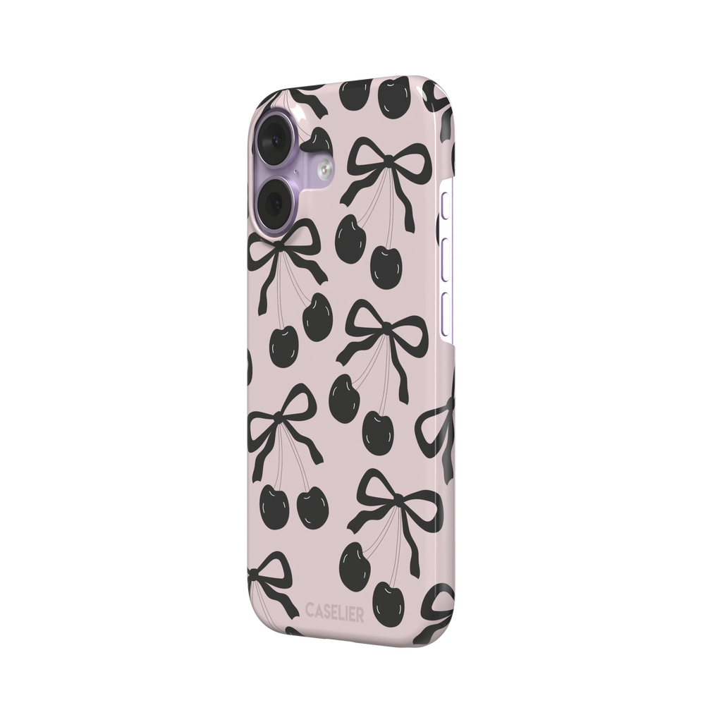Black Cherry phone case with an all-over pattern of black cherries and ribbon bows on a blush pink background, phone case by Caselier — snap case, right view