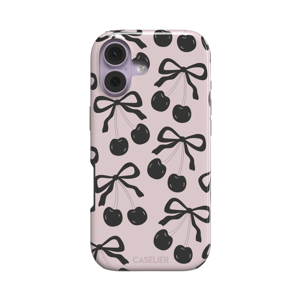 Black Cherry phone case with an all-over pattern of black cherries and ribbon bows on a blush pink background, phone case by Caselier — tough case, front view