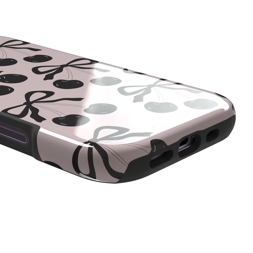 Black Cherry phone case with an all-over pattern of black cherries and ribbon bows on a blush pink background, phone case by Caselier — tough case, charging port detail