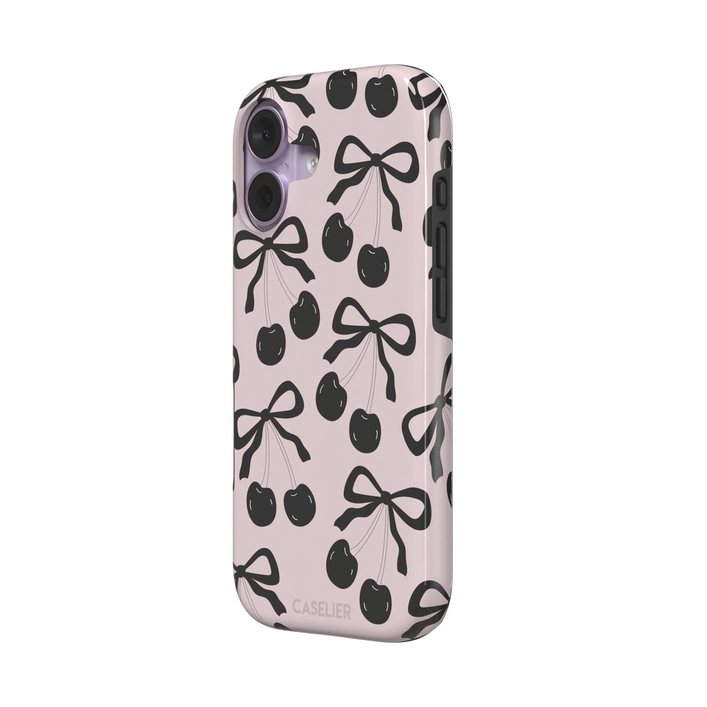 Black Cherry phone case with an all-over pattern of black cherries and ribbon bows on a blush pink background, phone case by Caselier — tough case, right view