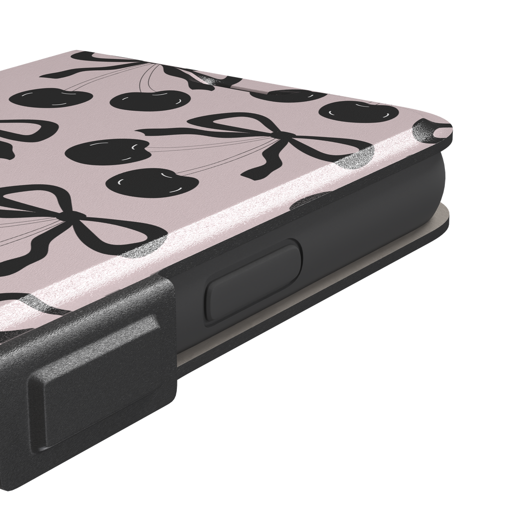 Black Cherry phone case with an all-over pattern of black cherries and ribbon bows on a blush pink background, phone case by Caselier — wallet case, volume buttons detail
