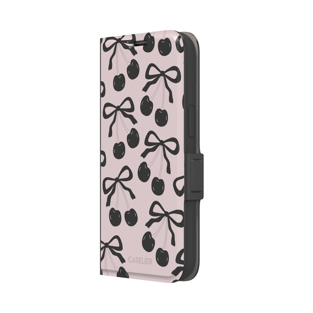 Black Cherry phone case with an all-over pattern of black cherries and ribbon bows on a blush pink background, phone case by Caselier — wallet case, right view