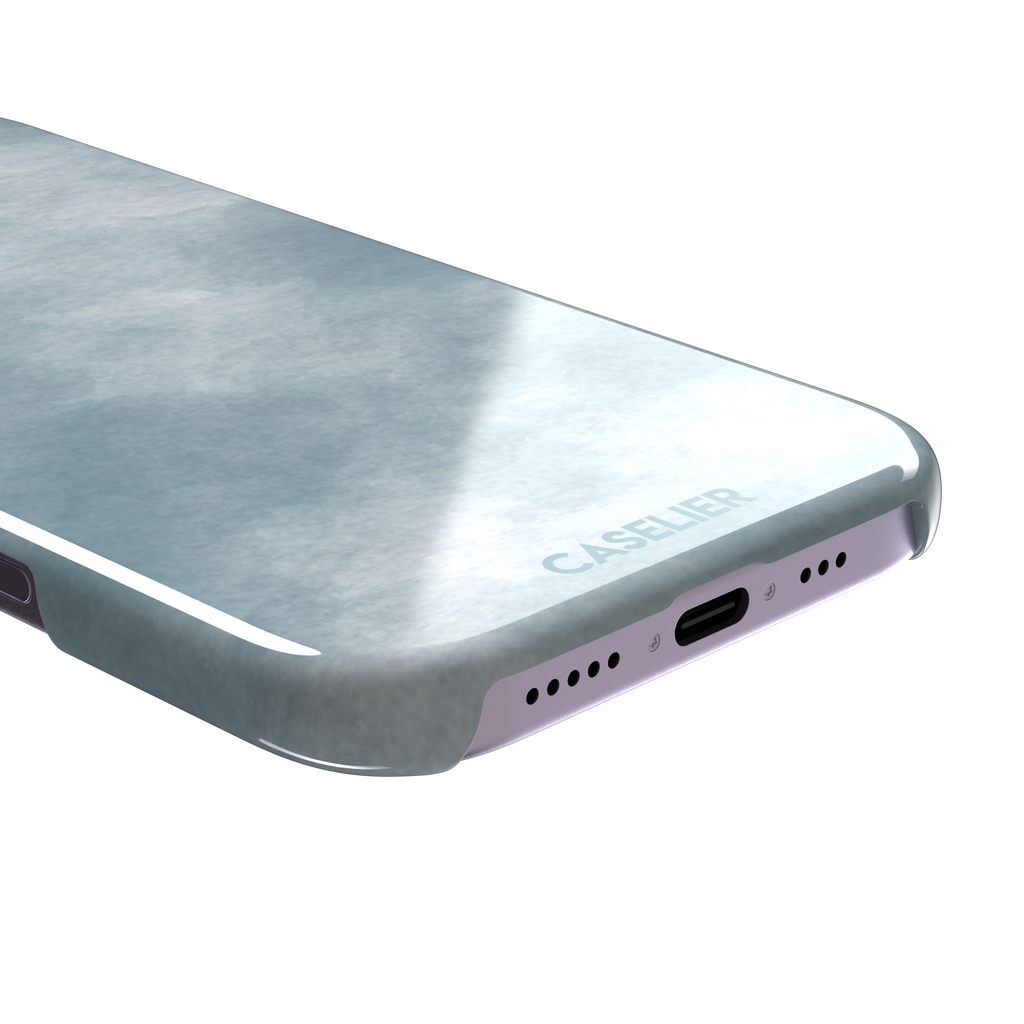 Soft powder-blue watercolor wash phone case with misty white cloud-like blends, phone case by Caselier — snap case, charging port detail