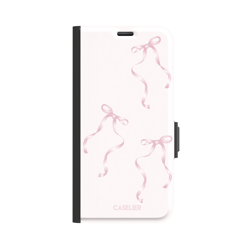 Bows phone case with scattered pink satin ribbon bows on a soft blush background, coquette style, phone case by Caselier — wallet case, front view