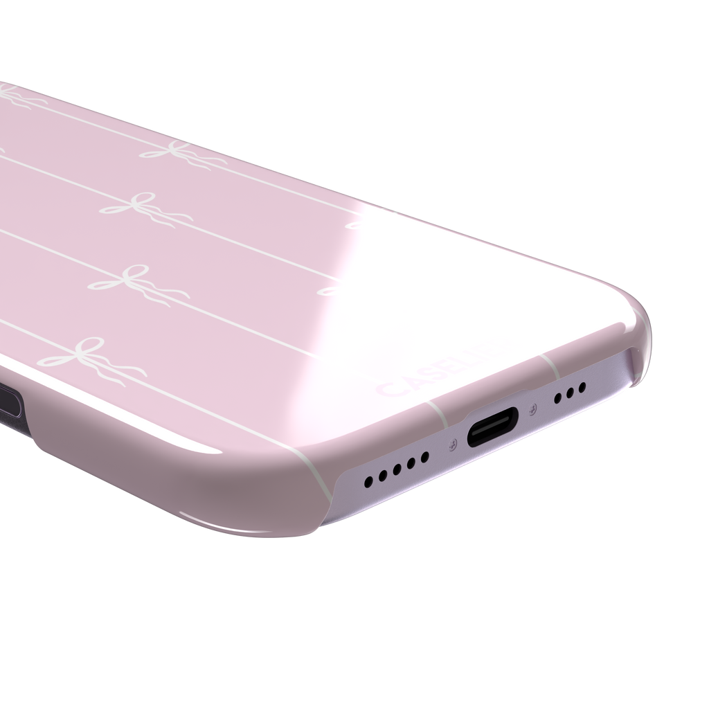 Bows on String phone case in pale pink with white bow and stripe repeat pattern, phone case by Caselier — snap case, charging port detail