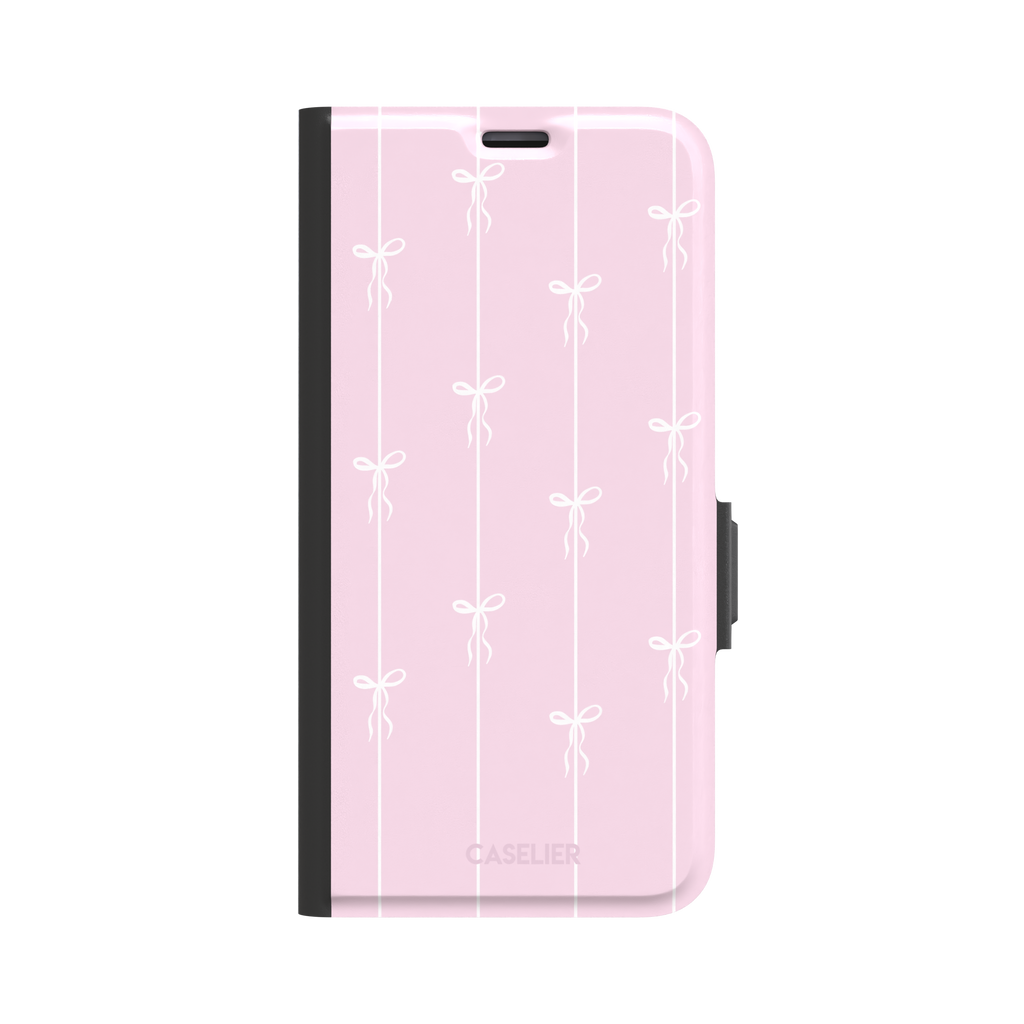 Bows on String phone case in pale pink with white bow and stripe repeat pattern, phone case by Caselier — wallet case, front view