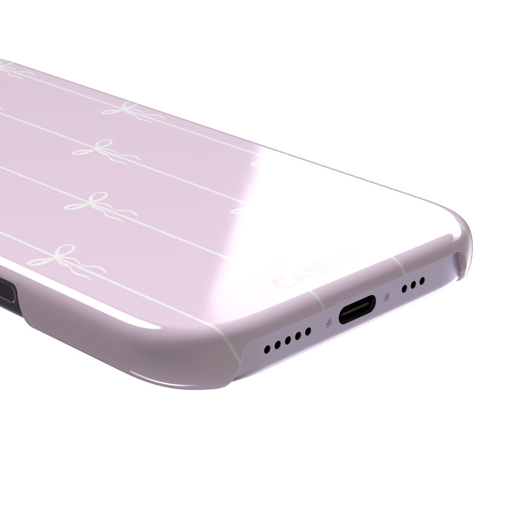 Bows on String phone case in soft lilac pink with white ribbon bows on vertical stripes, phone case by Caselier — snap case, charging port detail