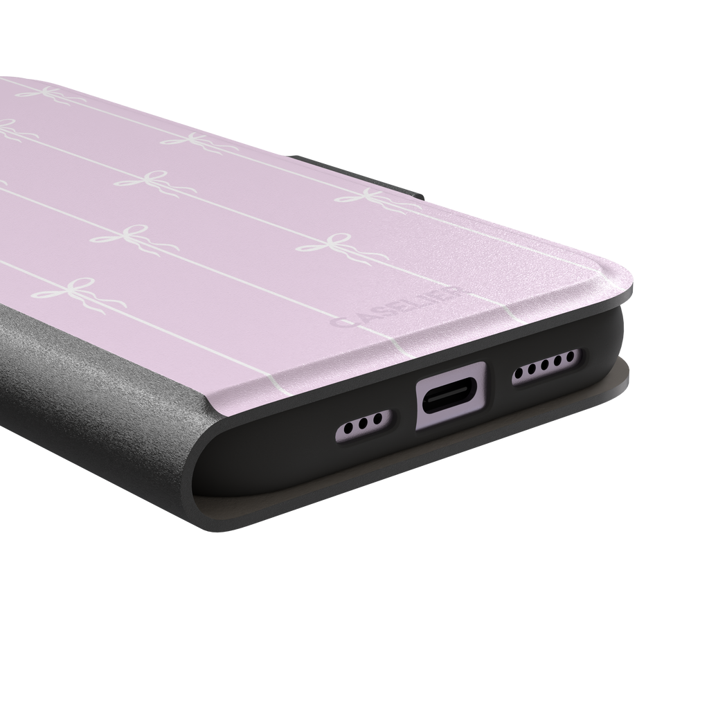 Bows on String phone case in soft lilac pink with white ribbon bows on vertical stripes, phone case by Caselier — wallet case, charging port detail