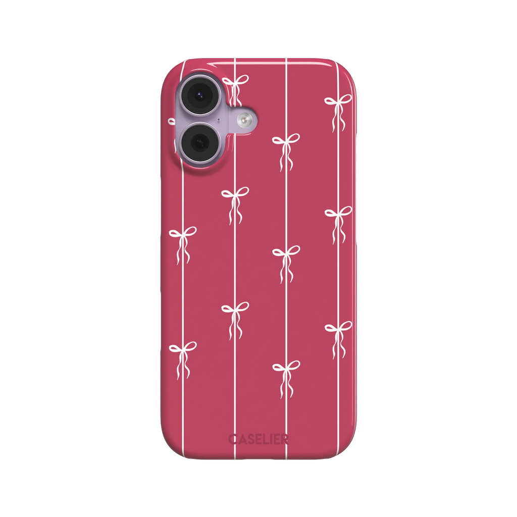 Bows on String phone case in raspberry pink with white ribbon bows tied along vertical stripes, phone case by Caselier — snap case, front view