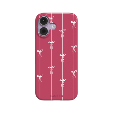 Bows on String phone case in raspberry pink with white ribbon bows tied along vertical stripes, phone case by Caselier — snap case, front view