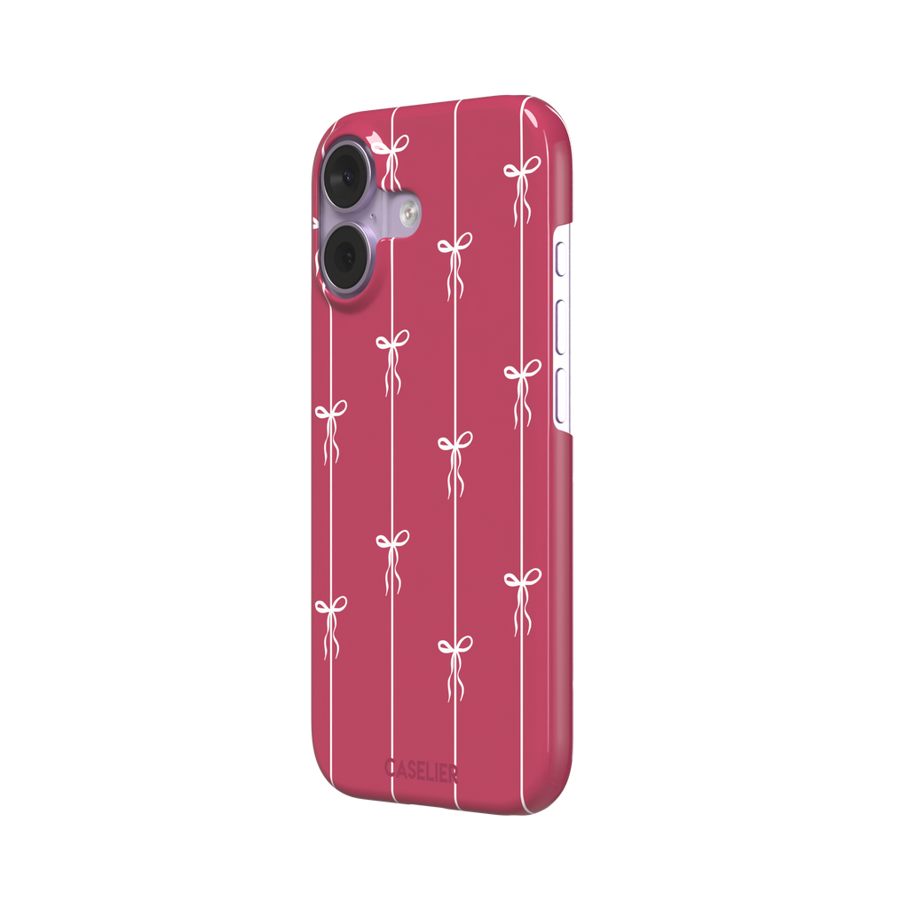 Bows on String phone case in raspberry pink with white ribbon bows tied along vertical stripes, phone case by Caselier — snap case, right view