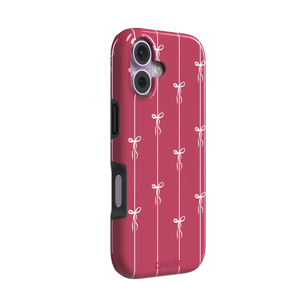 Bows on String phone case in raspberry pink with white ribbon bows tied along vertical stripes, phone case by Caselier — tough case, left view