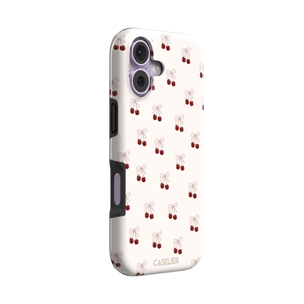 Cherry Bow phone case with glossy red cherries and delicate line-drawn bows scattered across a cream background, coquette style, phone case by Caselier — tough case, left view