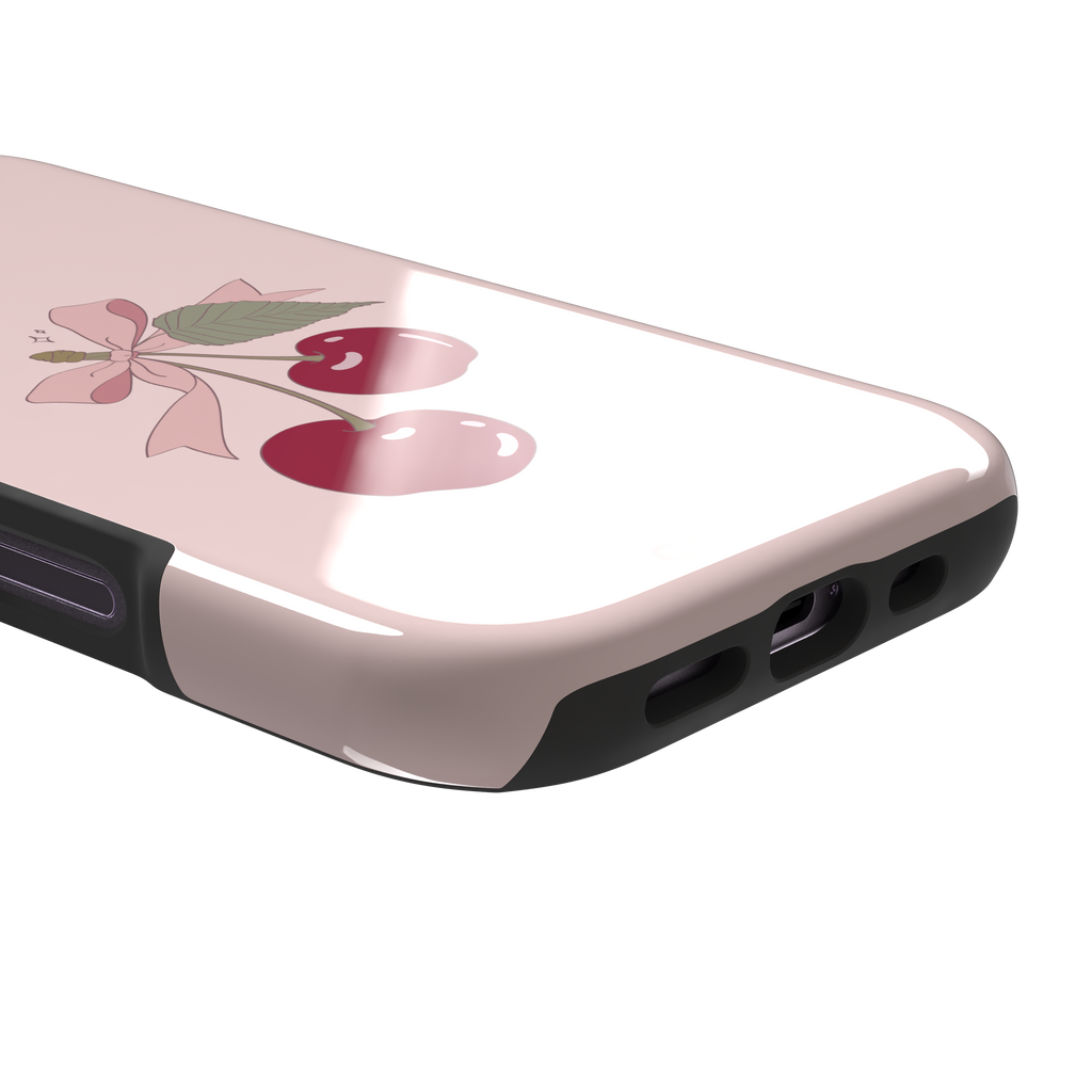 Soft pink phone case featuring two glossy red cherries tied with a pink ribbon bow and green leaf illustration in a coquette style, phone case by Caselier — tough case, charging port detail