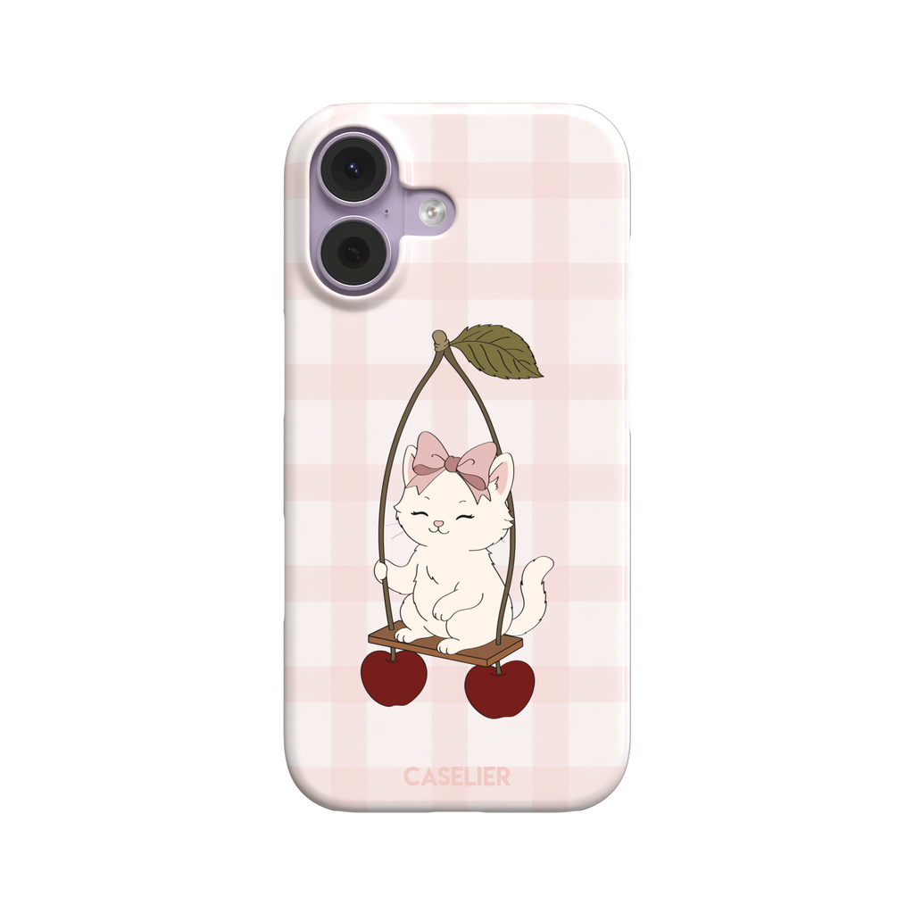 Cherry Swing phone case featuring a white cartoon kitten with a pink bow sitting on a cherry-suspended swing over a blush pink gingham background, phone case by Caselier — snap case, front view