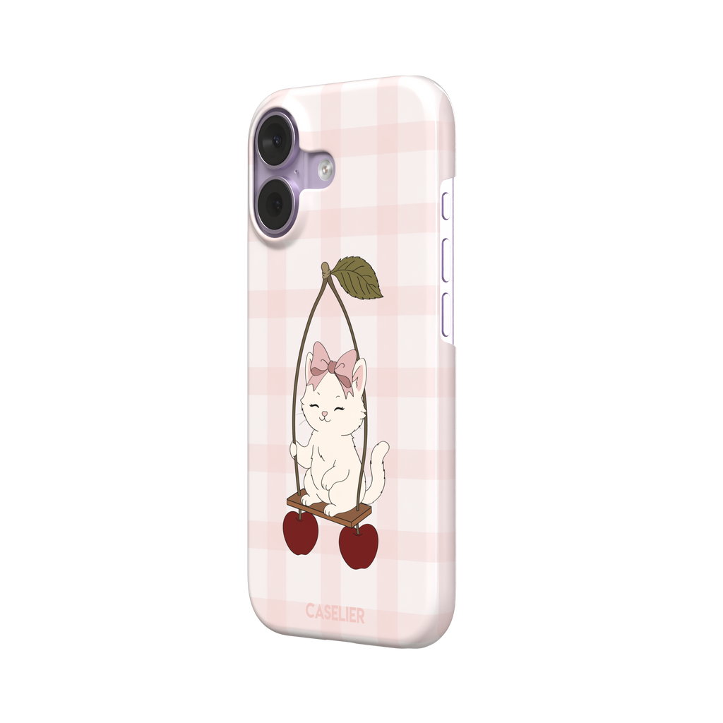 Cherry Swing phone case featuring a white cartoon kitten with a pink bow sitting on a cherry-suspended swing over a blush pink gingham background, phone case by Caselier — snap case, right view