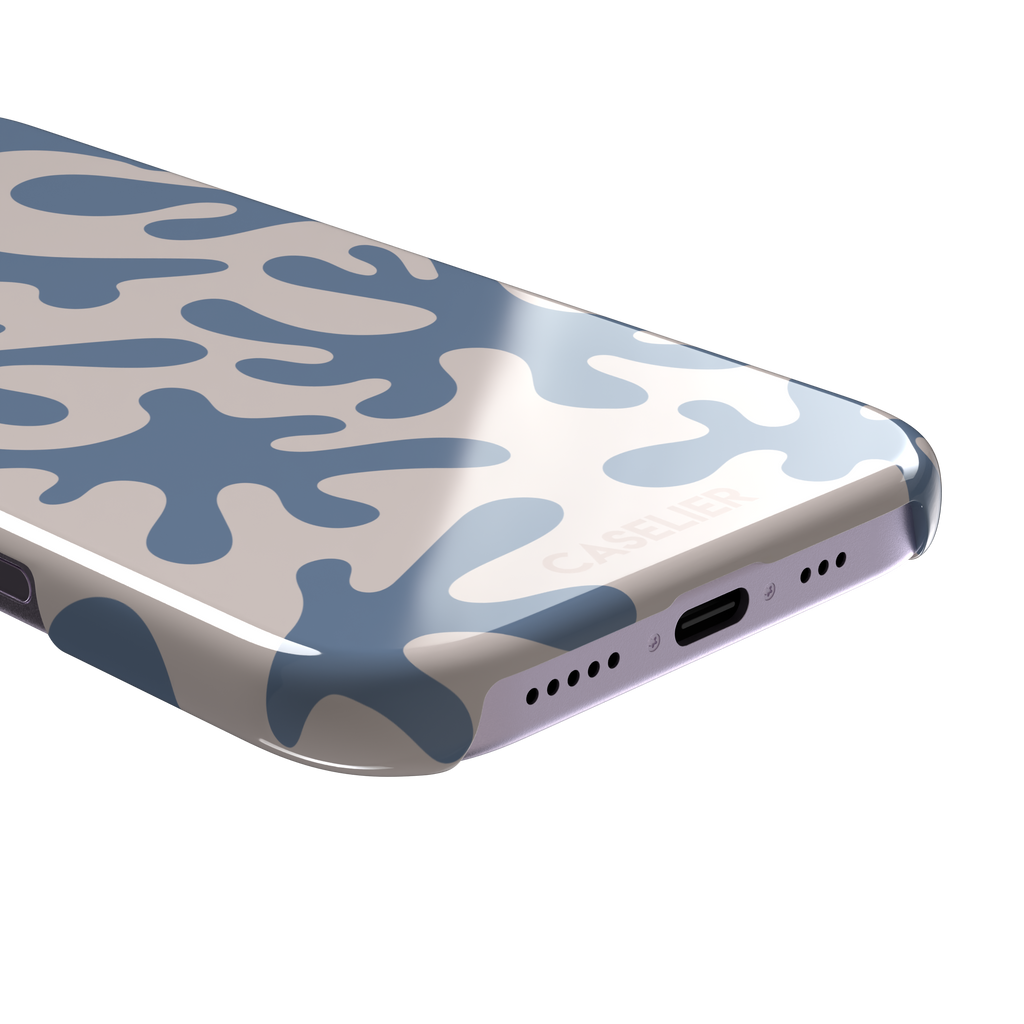 Coral Reef phone case in slate blue and warm beige with an all-over branching coral abstract pattern, phone case by Caselier — snap case, charging port detail