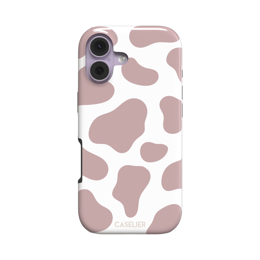 Cow print phone case in dusty rose pink and white with large soft-edged spots across the full back, phone case by Caselier — tough case, front view
