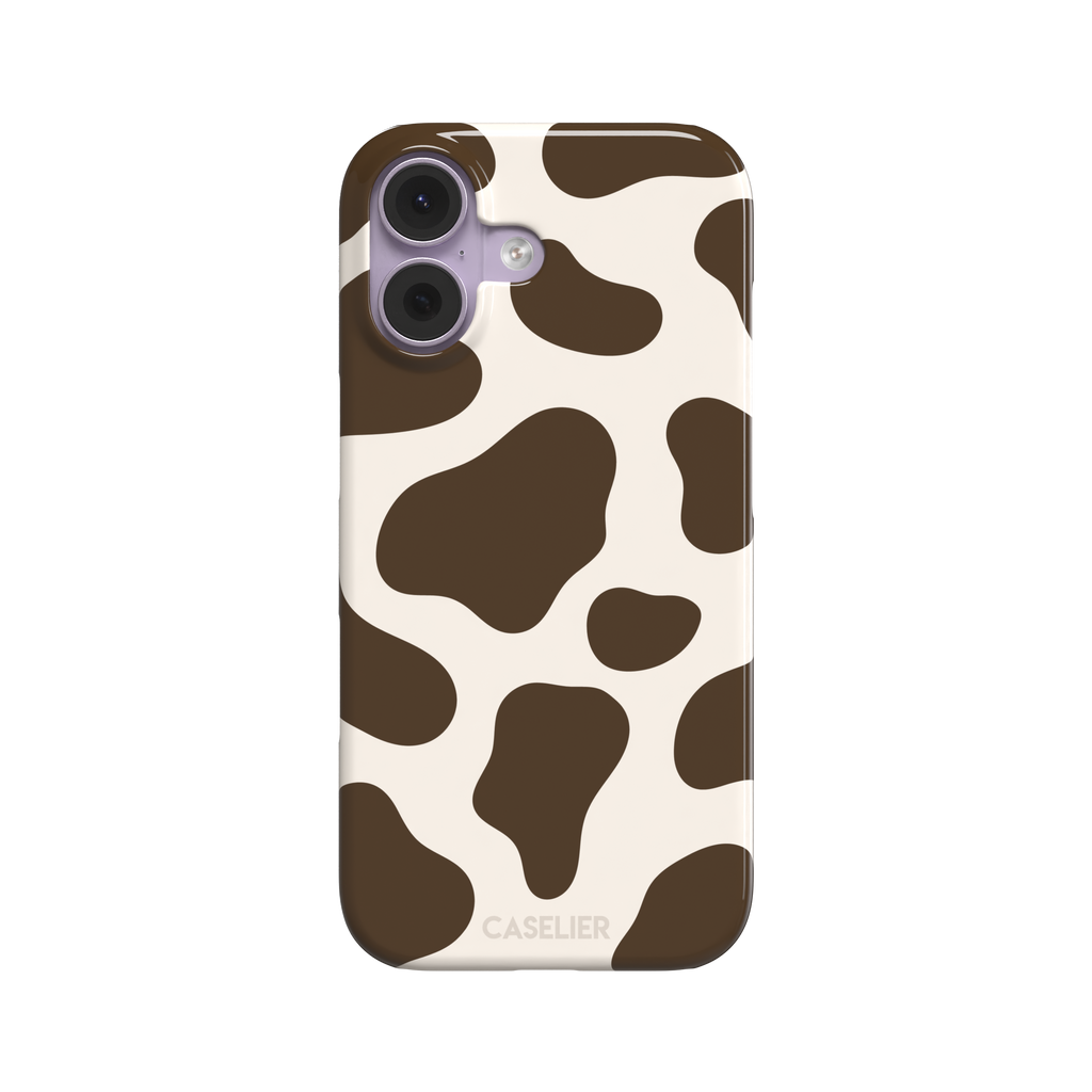 Cow print phone case in deep brown and cream with large irregular spots covering the full back, phone case by Caselier — snap case, front view