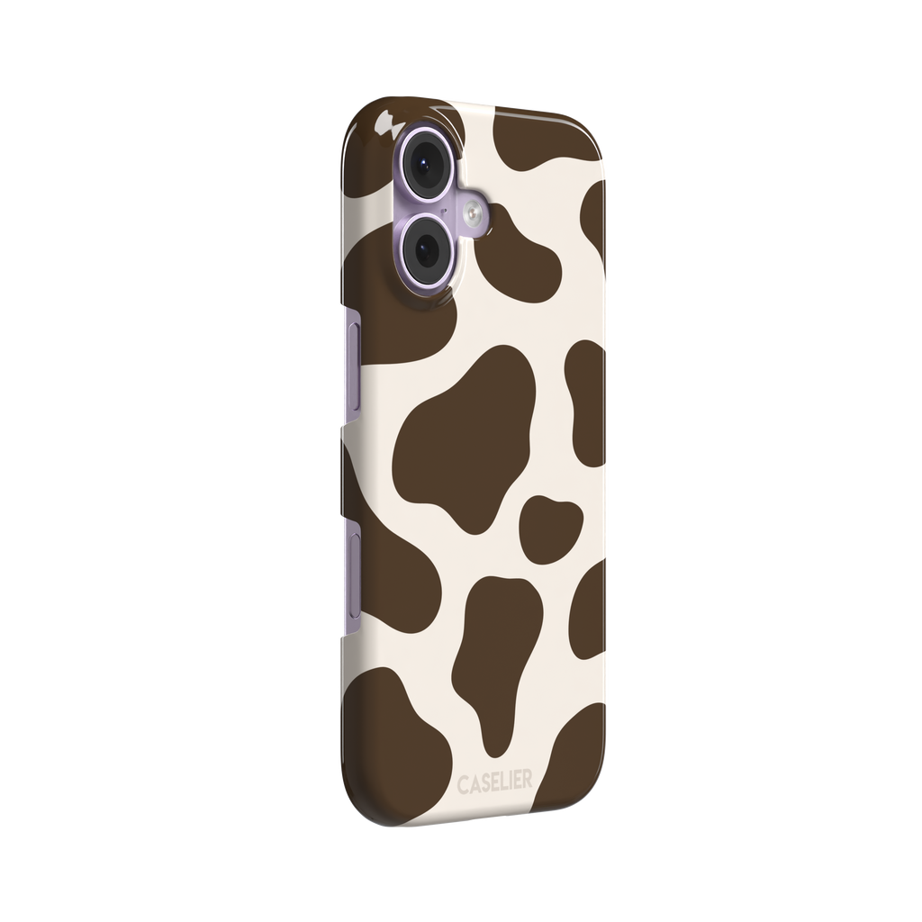 Cow print phone case in deep brown and cream with large irregular spots covering the full back, phone case by Caselier — snap case, left view