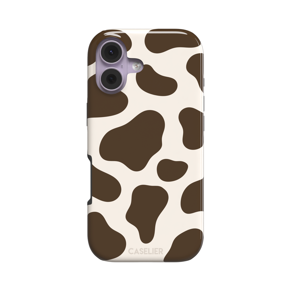 Cow print phone case in deep brown and cream with large irregular spots covering the full back, phone case by Caselier — tough case, front view
