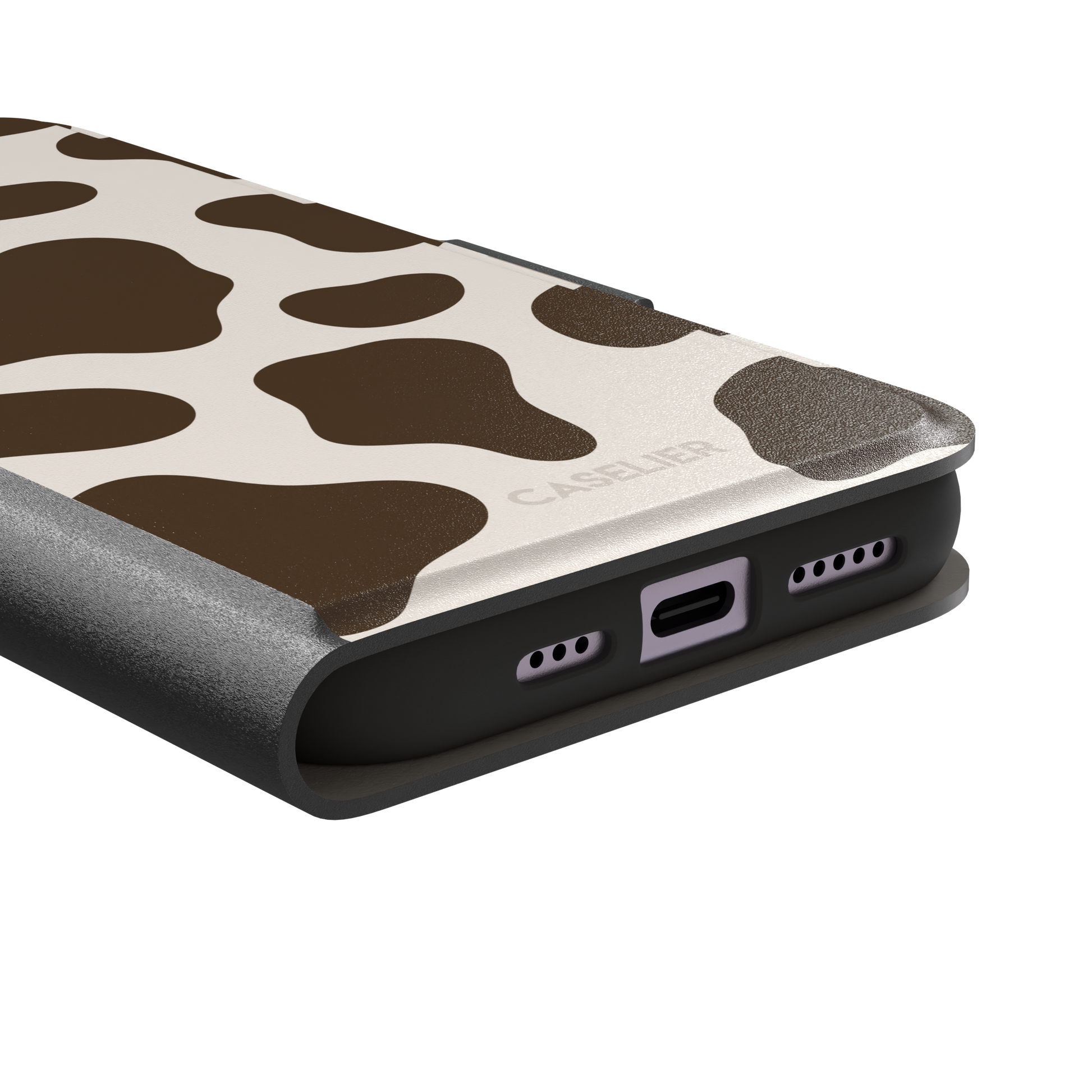 Cow print phone case in deep brown and cream with large irregular spots covering the full back, phone case by Caselier — wallet case, charging port detail