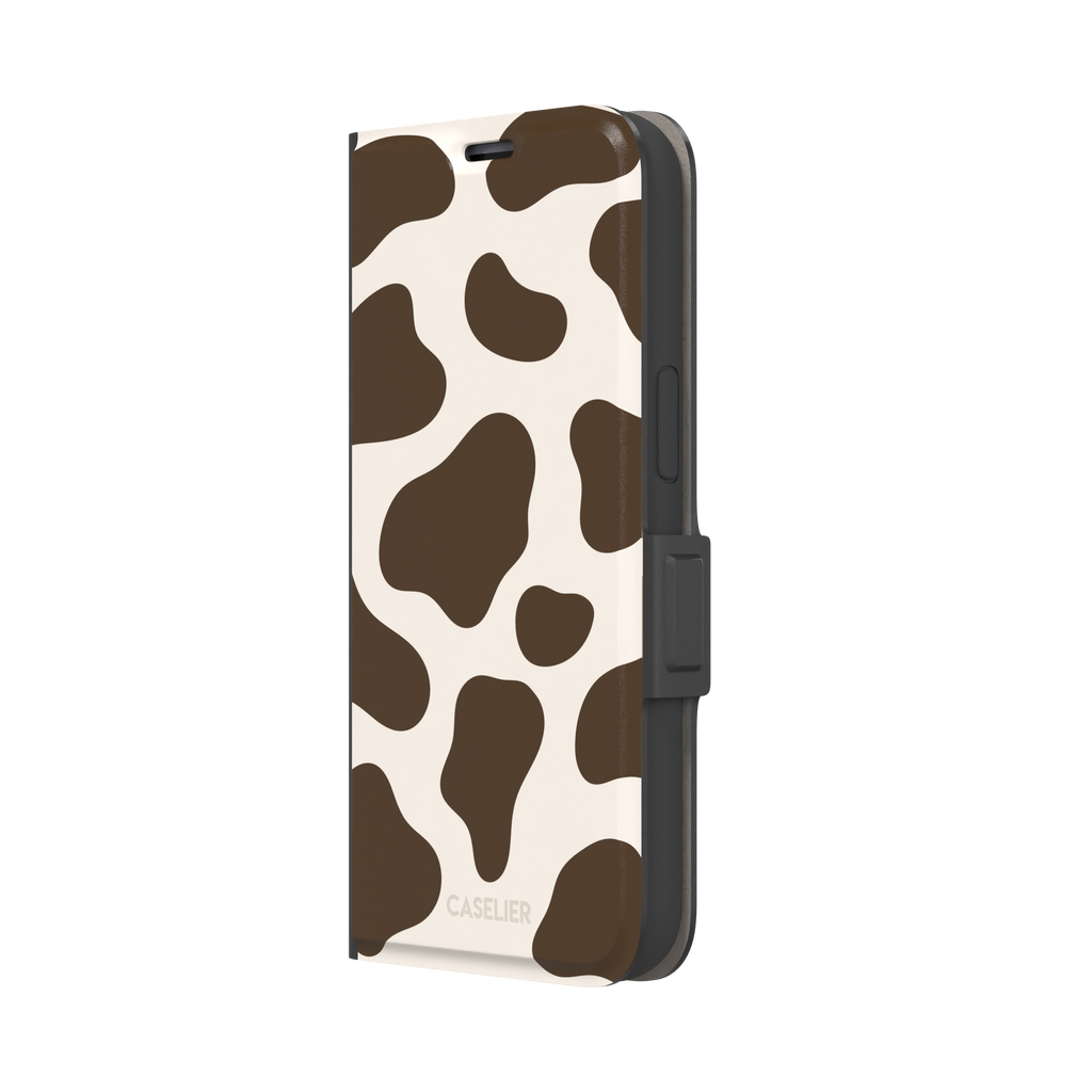 Cow print phone case in deep brown and cream with large irregular spots covering the full back, phone case by Caselier — wallet case, right view