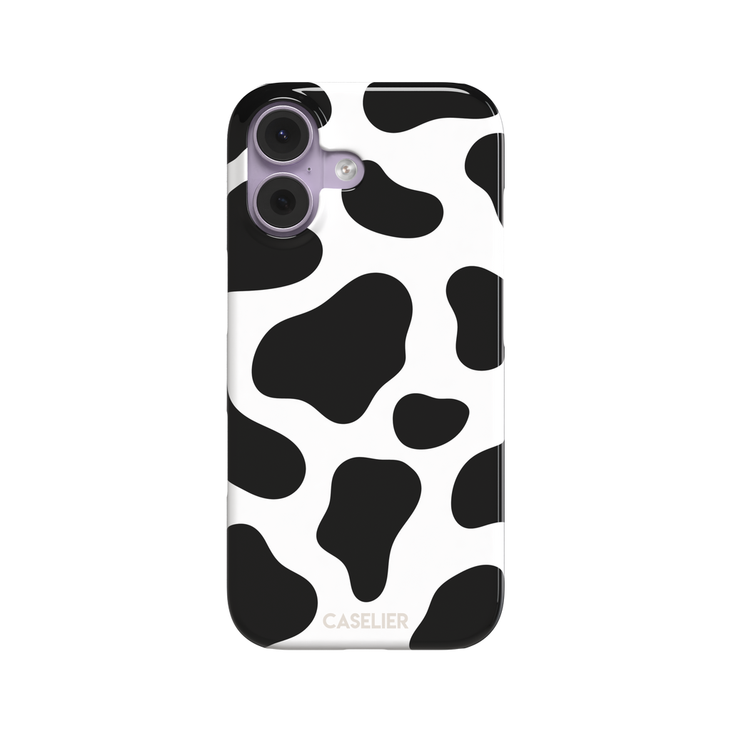 Cow print phone case in black and white with bold oversized spots on a clean white background, phone case by Caselier — snap case, front view