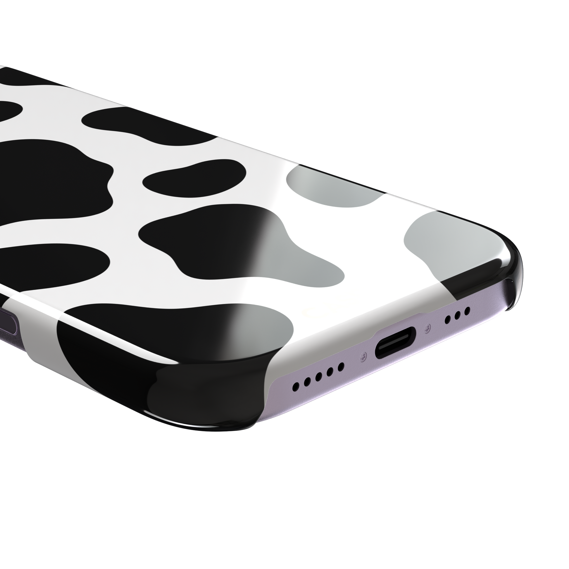 Cow print phone case in black and white with bold oversized spots on a clean white background, phone case by Caselier — snap case, charging port detail