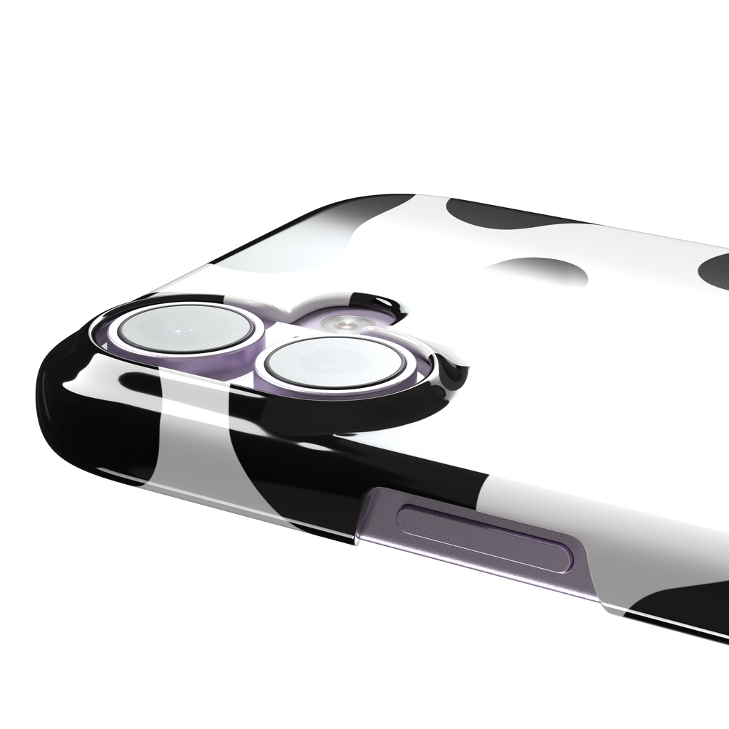Cow print phone case in black and white with bold oversized spots on a clean white background, phone case by Caselier — snap case, volume buttons detail