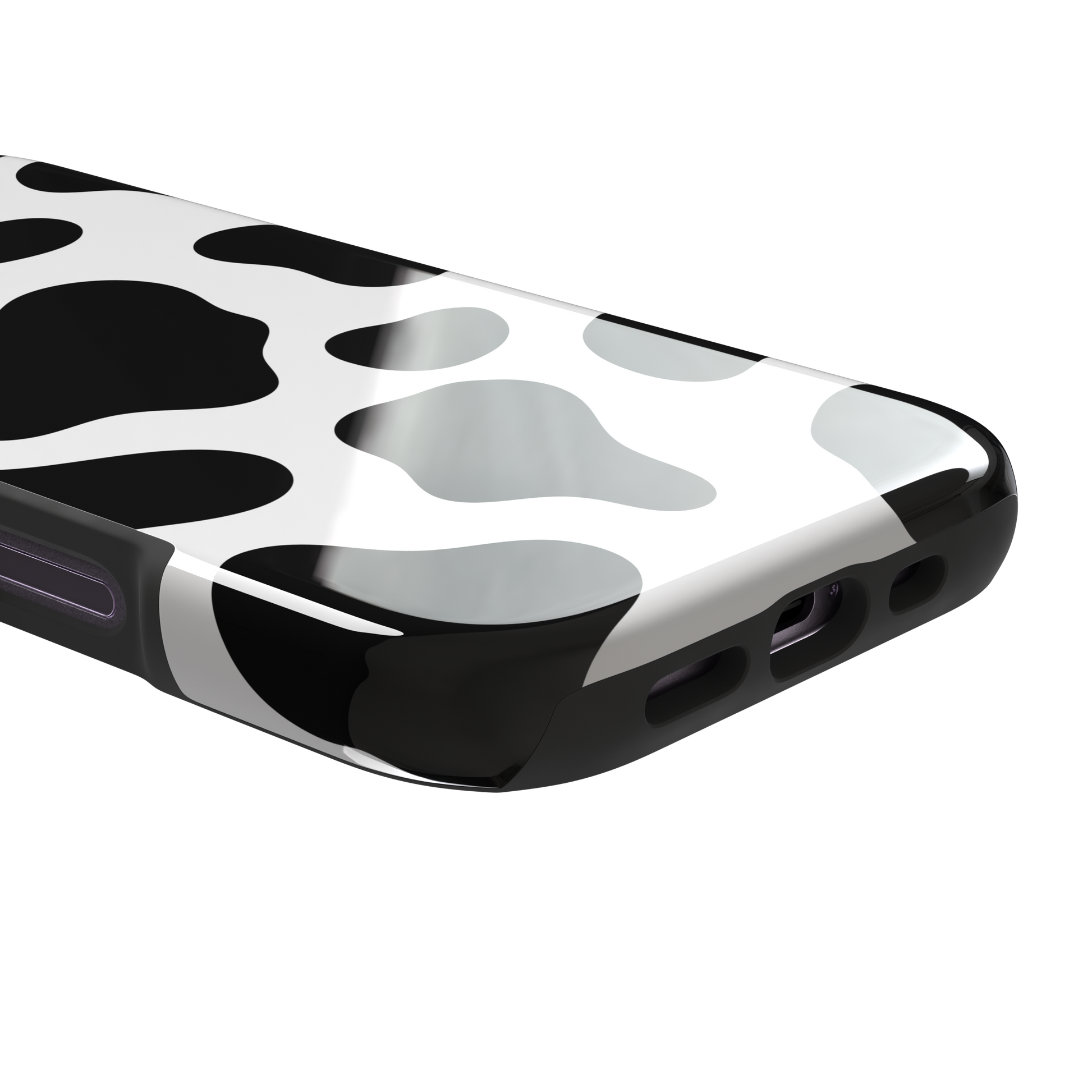 Cow print phone case in black and white with bold oversized spots on a clean white background, phone case by Caselier — tough case, charging port detail