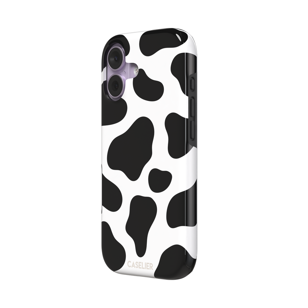 Cow print phone case in black and white with bold oversized spots on a clean white background, phone case by Caselier — tough case, right view