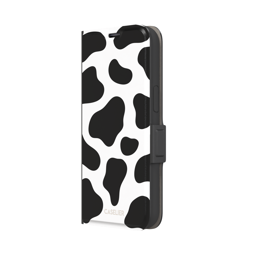 Cow print phone case in black and white with bold oversized spots on a clean white background, phone case by Caselier — wallet case, right view