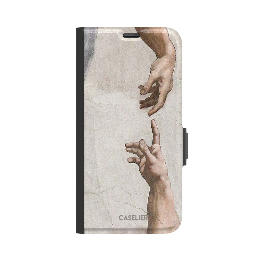 Creation of Adam phone case showing Michelangelo's two reaching hands in warm ivory and skin tones against a cracked fresco background, phone case by Caselier — wallet case, front view
