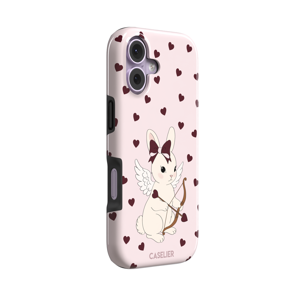 Blush pink phone case featuring a winged white cupid bunny with a burgundy bow and arrow surrounded by dark red hearts, phone case by Caselier — tough case, left view