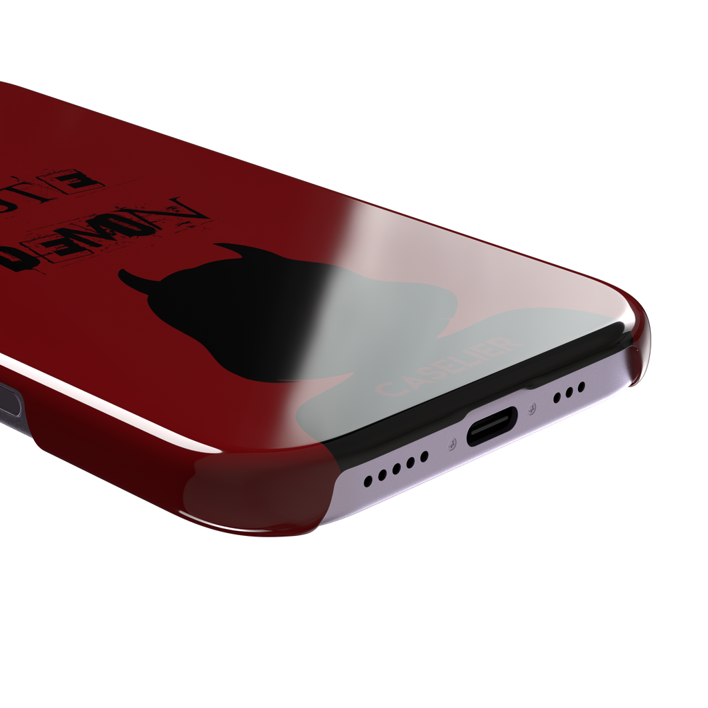 Cute Demon phone case in deep red with black devil-horned silhouette and distressed Cute Demon text, phone case by Caselier — snap case, charging port detail