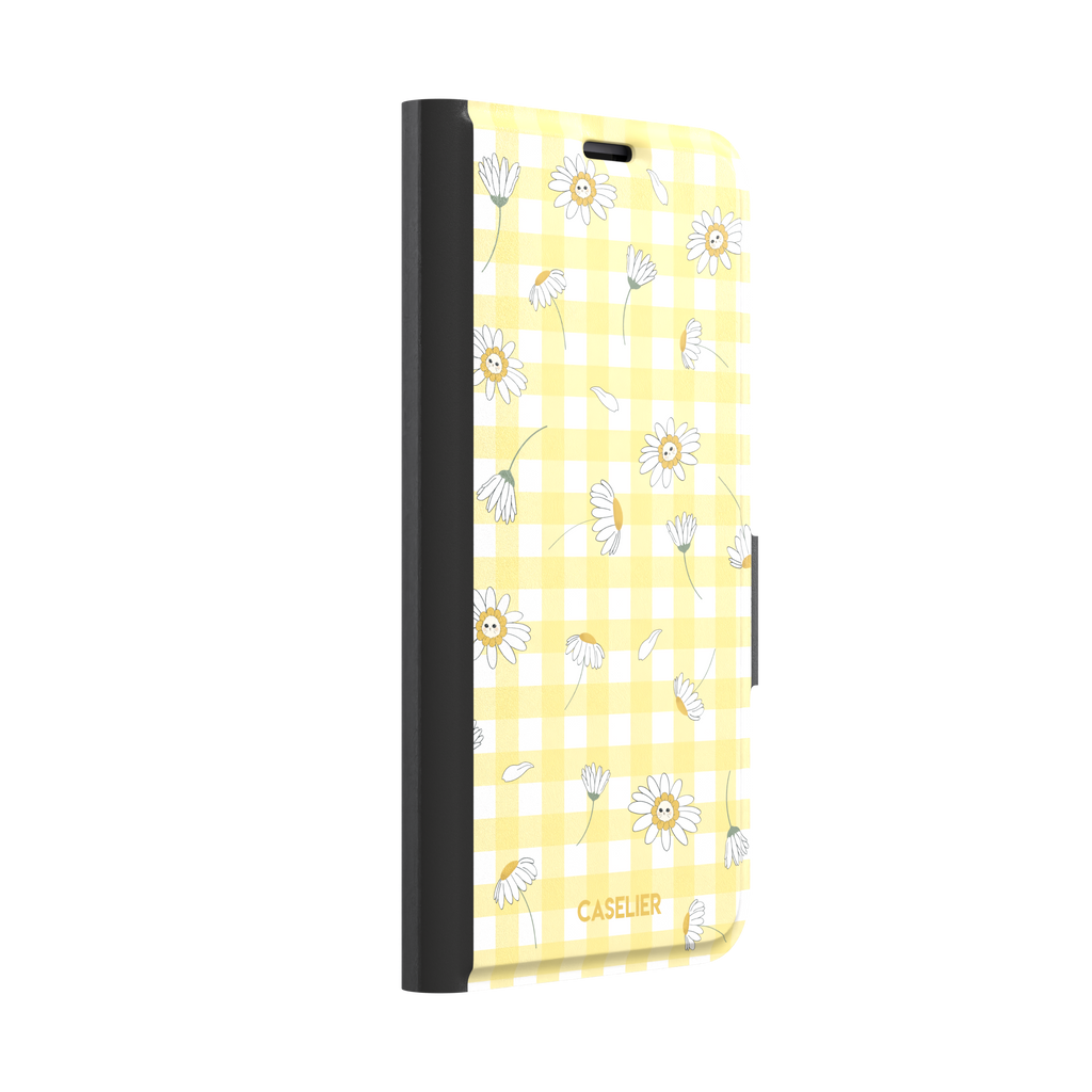 Daisies phone case variant showing white daisy flowers with small smiley faces at their centres on a yellow gingham background, phone case by Caselier — wallet case, left view | Caselier