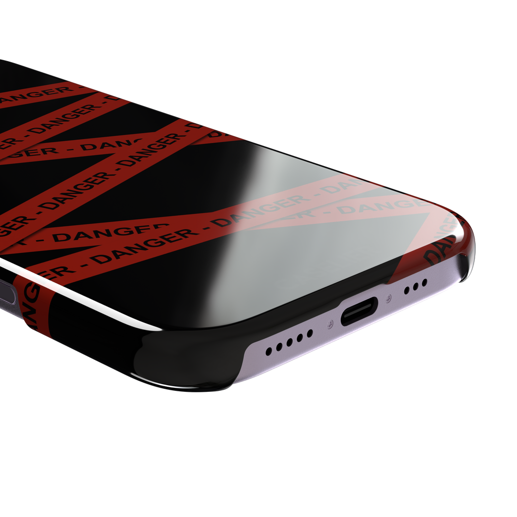 Black phone case with criss-crossing red danger tape strips printed diagonally across the back, featuring bold repeated DANGER text in black lettering — snap case, charging port detail
