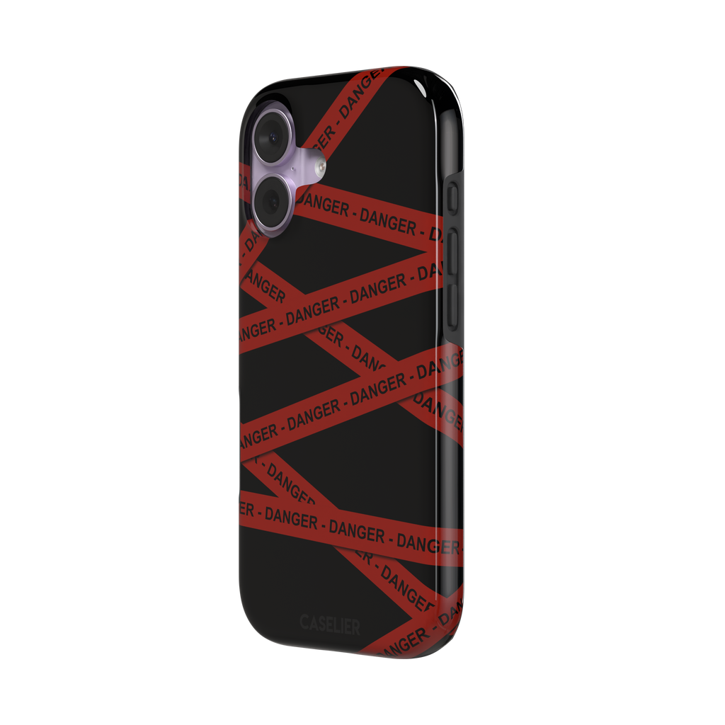 Black phone case with criss-crossing red danger tape strips printed diagonally across the back, featuring bold repeated DANGER text in black lettering — tough case, right view