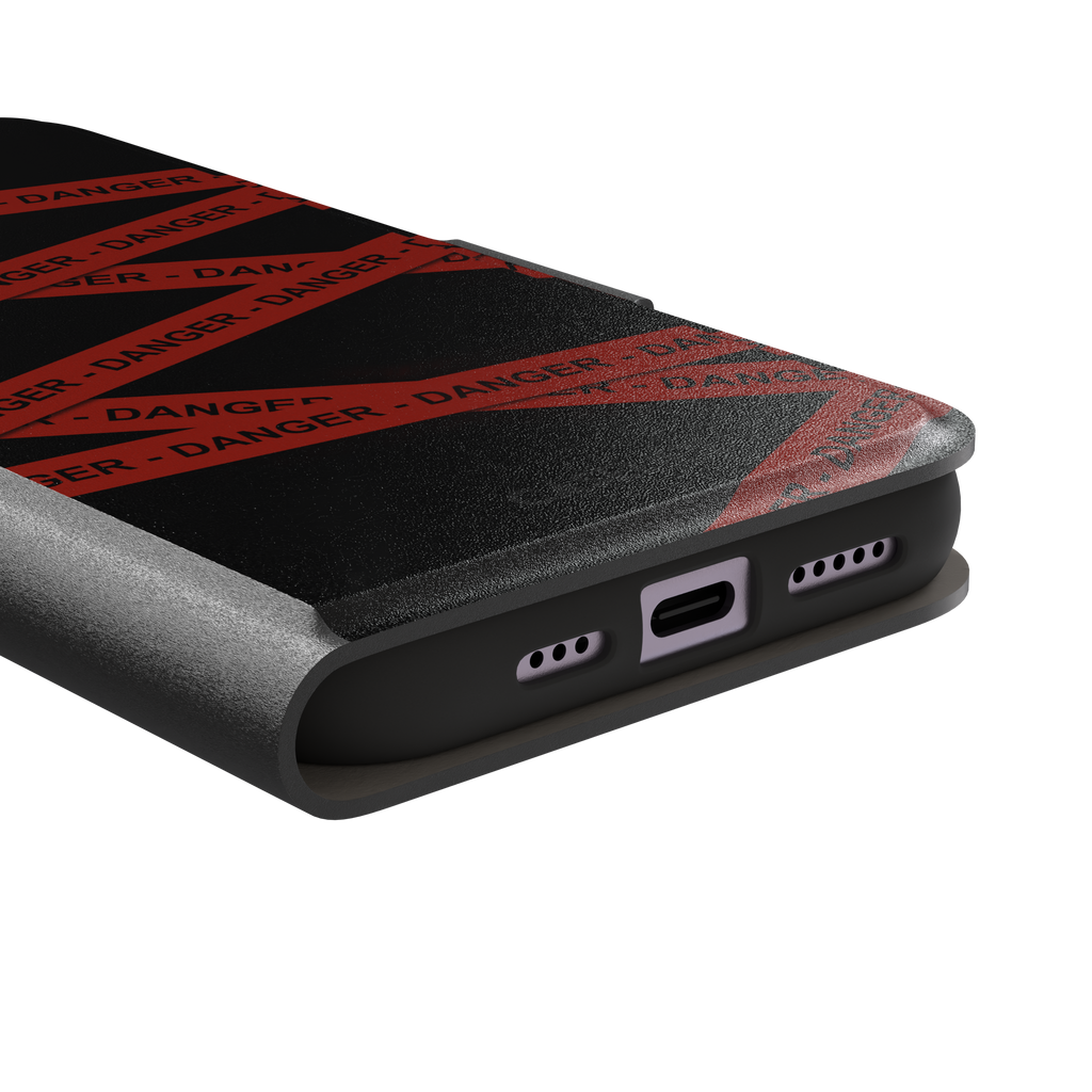 Black phone case with criss-crossing red danger tape strips printed diagonally across the back, featuring bold repeated DANGER text in black lettering — wallet case, charging port detail